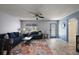 Cozy living room with a blue sofa, decorative pillows, and a glass coffee table at 2003 Cordero Ct, The Villages, FL 32159
