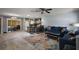 Open living area with a vibrant rug, comfortable blue sofas, and kitchen in the background at 2003 Cordero Ct, The Villages, FL 32159
