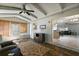 Bright sunroom with wood-look floors, ceiling fan, and doorway to the living area provides a comfortable relaxing space at 2003 Cordero Ct, The Villages, FL 32159