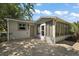 Back of house featuring sunny lanai, brick patio and tropical foliage at 2003 Cordero Ct, The Villages, FL 32159