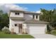 Charming two-story home with a neutral color scheme, stone accents and an attached two-car garage at 2004 Sunshine Peak Dr, Minneola, FL 34715