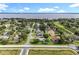 Beautiful aerial view of community showcasing mature trees, landscaping, and stunning lake backdrop at 2024 Meadowside Dr, Eustis, FL 32726