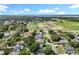 Expansive aerial view of a residential community with lush greenery, waterfront views, and newly constructed homes at 2024 Meadowside Dr, Eustis, FL 32726