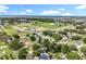 Gorgeous aerial view of neighborhood, showcasing lush greenery, new construction, and distant lake views at 2024 Meadowside Dr, Eustis, FL 32726