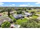 Aerial view showcasing a home with green lawn, screened pool and mature trees at 2024 Meadowside Dr, Eustis, FL 32726