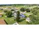 Property featuring solar panels, screened-in pool, large yard, and beautiful landscaping in residential neighborhood at 2024 Meadowside Dr, Eustis, FL 32726