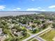 Aerial view of a peaceful neighborhood with lake views and lush greenery at 2024 Meadowside Dr, Eustis, FL 32726