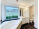 Bathroom featuring a soaking tub, window with outside view and a toilet room at 2024 Meadowside Dr, Eustis, FL 32726