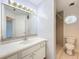 Bathroom with a large mirror above the sink vanity, toilet and shower at 2024 Meadowside Dr, Eustis, FL 32726
