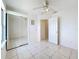 The bedroom features a ceiling fan, closet with mirrored sliding doors and backyard view at 2024 Meadowside Dr, Eustis, FL 32726