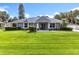 Charming single-story home featuring a well-manicured lawn, double door entryway, and a freshly painted exterior at 2024 Meadowside Dr, Eustis, FL 32726