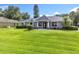 Charming single-story home featuring a well-manicured lawn, double door entryway, and a freshly painted exterior at 2024 Meadowside Dr, Eustis, FL 32726