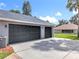Three-car garage with dark doors and long driveway provides ample parking at 2024 Meadowside Dr, Eustis, FL 32726