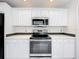 Close up of stainless steel stove and microwave with white cabinetry at 2024 Meadowside Dr, Eustis, FL 32726