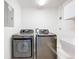 Bright laundry room with side by side washer and dryer for easy laundry access at 2024 Meadowside Dr, Eustis, FL 32726