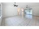 Bright living room featuring tile flooring, arched doorways, and sliding glass doors with a pool view at 2024 Meadowside Dr, Eustis, FL 32726