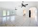 Bright and open living room with tile floors, ceiling fans, and French doors that open to the outdoor area at 2024 Meadowside Dr, Eustis, FL 32726