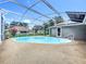 Inviting screened-in pool with a white frame, surrounded by a textured deck, providing a private outdoor space at 2024 Meadowside Dr, Eustis, FL 32726