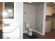 Bathroom featuring a modern sink and vanity next to a toilet and laundry area at 23515 Poinsettia Ave, Fruitland Park, FL 34731