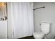 Cozy bathroom featuring a white shower curtain, dark flooring, and a vanity at 23515 Poinsettia Ave, Fruitland Park, FL 34731