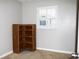 Clean bedroom with carpet, neutral paint, a shuttered window, and a unique wooden shelving unit at 23515 Poinsettia Ave, Fruitland Park, FL 34731