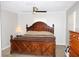 Spacious bedroom featuring a ceiling fan and large bed with a decorative headboard and a matching dresser at 23515 Poinsettia Ave, Fruitland Park, FL 34731
