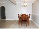 Cozy dining area featuring tile floors, an archway, and a classic wooden dining set with seating for four at 23515 Poinsettia Ave, Fruitland Park, FL 34731