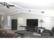 Cozy living room with a ceiling fan, comfortable seating, and a large television for entertainment at 23515 Poinsettia Ave, Fruitland Park, FL 34731