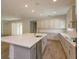 Bright kitchen features wood-look tile, stainless steel appliances and a large white center island at 2364 Juniper Berry Dr, Minneola, FL 34715
