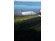 View of the backyard with a metal fence and a lake behind the house at 245 Blue Cypress Dr, Groveland, FL 34736