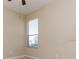 Bright, carpeted bedroom with natural light from window and ceiling fan at 245 Blue Cypress Dr, Groveland, FL 34736