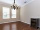 Traditional dining room with hardwood floors, a classic chandelier and large windows for natural light at 245 Blue Cypress Dr, Groveland, FL 34736