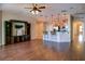 Open-concept living room with hardwood floors, breakfast bar, and pendant lighting at 245 Blue Cypress Dr, Groveland, FL 34736