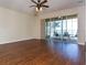 Expansive living room with hardwood floors and a screened-in lanai, offering stunning water views and seamless indoor-outdoor living at 245 Blue Cypress Dr, Groveland, FL 34736