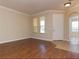 Bright living room with hardwood floors, crown molding, and large windows, providing an inviting and spacious feel at 245 Blue Cypress Dr, Groveland, FL 34736