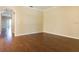 Spacious living room with hardwood floors and neutral walls, creating a versatile space for relaxation and entertainment at 245 Blue Cypress Dr, Groveland, FL 34736