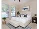 Beautiful main bedroom with an en suite bathroom, large windows, and a ceiling fan at 245 Blue Cypress Dr, Groveland, FL 34736