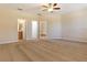 Large primary bedroom featuring neutral carpet and a ceiling fan, providing a comfortable retreat at 245 Blue Cypress Dr, Groveland, FL 34736
