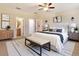 Comfortable main bedroom featuring a large bed, ceiling fan, and coordinated decor at 245 Blue Cypress Dr, Groveland, FL 34736