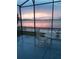Enjoy a scenic lake view and sunset on the screened patio at 245 Blue Cypress Dr, Groveland, FL 34736