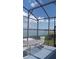 Screened patio overlooking a lake, featuring outdoor seating at 245 Blue Cypress Dr, Groveland, FL 34736