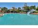 Large community pool with waterslide, lounge seating, and shade structures at 245 Blue Cypress Dr, Groveland, FL 34736