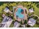Aerial view of community pool with slide, lounge chairs, and lush landscaping at 245 Blue Cypress Dr, Groveland, FL 34736