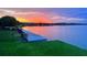 Scenic waterfront with a dock and beautiful sunset views, perfect for relaxing and enjoying the peaceful surroundings at 245 Blue Cypress Dr, Groveland, FL 34736