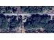 Aerial view of property showing roof and surrounding trees and proximity to Sailboat Drive at 24892 Sw Sailboat Dr, Dunnellon, FL 34431
