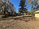 Large backyard featuring a shed, stone well, and mature trees at 24892 Sw Sailboat Dr, Dunnellon, FL 34431