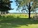 Expansive backyard with lawn rolling to a lake at 24892 Sw Sailboat Dr, Dunnellon, FL 34431