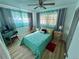 Cozy bedroom with light wood floors, ample natural light, and a comfortable-sized desk at 24892 Sw Sailboat Dr, Dunnellon, FL 34431