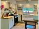 Well-lit kitchen with modern appliances, butcher block countertops, and ample storage space at 24892 Sw Sailboat Dr, Dunnellon, FL 34431