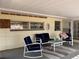 Inviting covered patio featuring comfortable outdoor furniture and serene views of the neighborhood at 24892 Sw Sailboat Dr, Dunnellon, FL 34431